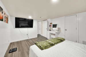 Bedroom featuring wood finished floors and baseboards