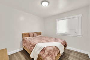 Bedroom featuring baseboards and wood finished floors