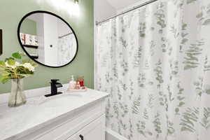 Full bath featuring vanity