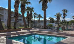 View of swimming pool with a patio and a residential view