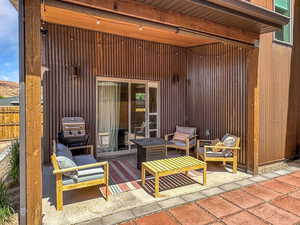 View of patio with an outdoor hangout area