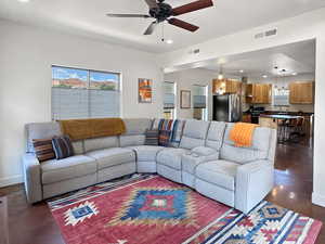 Living area featuring recessed lighting, a ceiling fan, concrete floors, and baseboards
