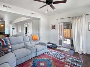 Living area with attic access, ceiling fan, baseboards, and recessed lighting