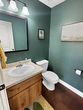 Half bathroom with vanity and toilet
