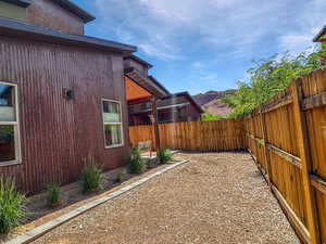 Fenced backyard featuring a mountain view