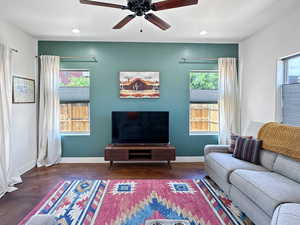 Living room with plenty of natural light, baseboards, finished concrete flooring, and recessed lighting