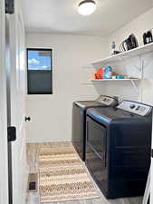 Laundry room with separate washer and dryer and baseboards
