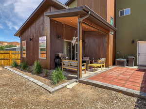 Rear view of property with a patio, central air condition unit, and an outdoor hangout area