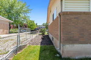 View of property exterior with brick and  siding