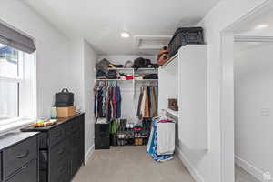 Spacious closet with light carpet