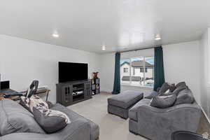 Carpeted living room featuring baseboards