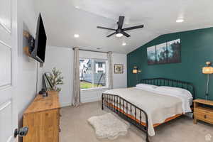 Carpeted bedroom featuring lofted ceiling, baseboards, recessed lighting, and ceiling fan