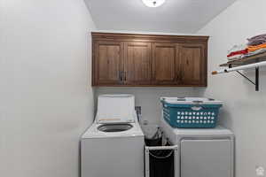 Laundry area featuring cabinet space and separate washer and dryer