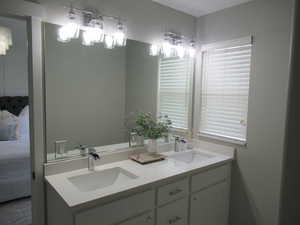 Bathroom with double vanity and connected bathroom