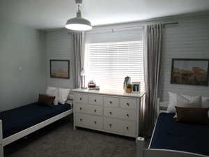 Bedroom featuring dark colored carpet