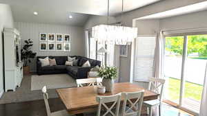 Dining area featuring wood finished floors, lofted ceiling, a chandelier, recessed lighting, and baseboards