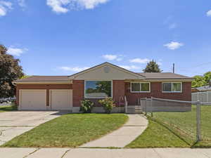 Ranch-style home with a garage, concrete driveway, and brick siding