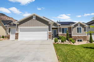 Craftsman inspired home featuring board and batten siding and stone