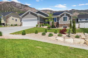 Craftsman house featuring board and batten siding and stone