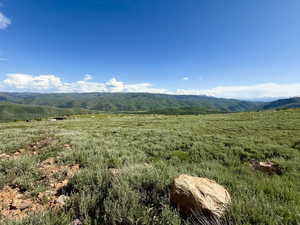 View of mountain backdrop featuring rolling hills