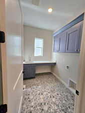 Washroom with hookup for a washing machine and cabinet space
