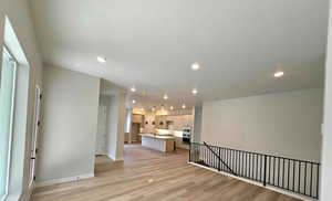 Unfurnished living room featuring light wood finished floors and recessed lighting