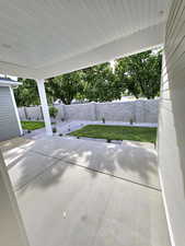 Fenced backyard featuring a covered patio