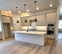 Quartz counter tops, corner walk-in pantry, wall ovens and gas cooktop