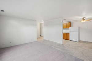 Unfurnished living room with a ceiling fan