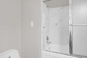 Bathroom featuring bathing tub / shower combination and toilet