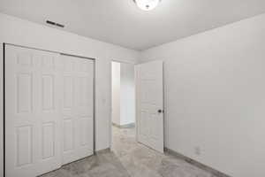 Unfurnished bedroom featuring baseboards and a closet