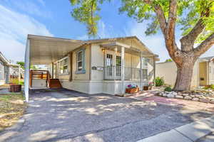 Manufactured / mobile home with a carport and driveway