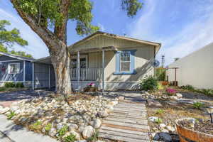 Manufactured / mobile home with covered porch and a carport