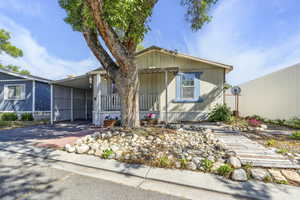Manufactured / mobile home featuring an attached carport and concrete driveway