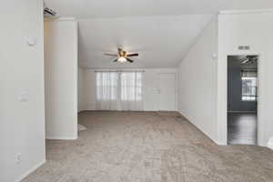 Spare room with carpet floors, ceiling fan, and baseboards