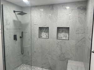 Bathroom with a marble finish shower