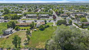Aerial view of property's location with a mountainous background and nearby suburban area