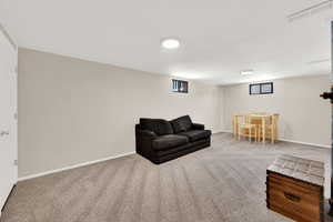 Living area with carpet flooring and baseboards