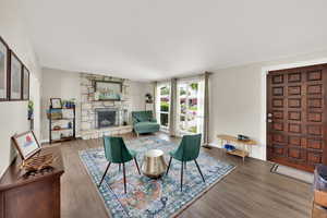 Living area featuring a fireplace, wood finished floors, and baseboards