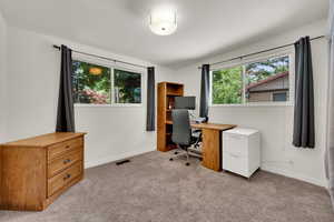 Carpeted office featuring baseboards