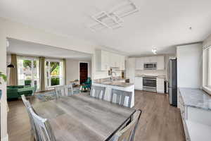 Dining area with light wood-style floors