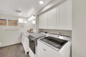 Laundry area with washer and dryer, baseboards, and a sink