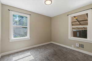 Unfurnished room with carpet and baseboards