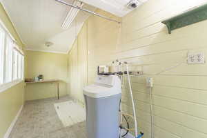 Washroom featuring brick patterned flooring and hookup for a washing machine