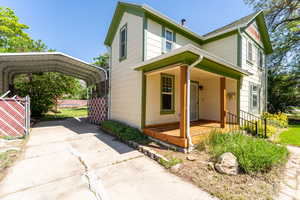 View of front of property featuring a detached carport and driveway