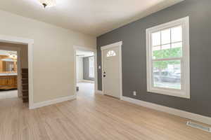 Entryway with light wood-type flooring, plenty of natural light, and baseboards