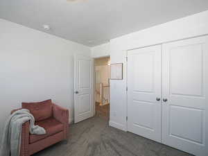 bedroom with carpet flooring, a textured ceiling, and baseboards
