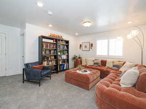 Carpeted living room featuring recessed lighting
