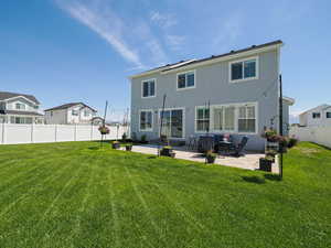 Rear view of property with stucco siding and a large patio