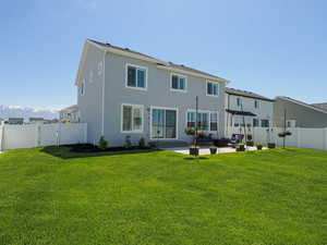 Back of property with an outdoor hangout area, a patio area, stucco siding, a gate, and a mountain view